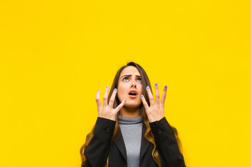 young pretty woman looking desperate and frustrated, stressed, unhappy and annoyed, shouting and...