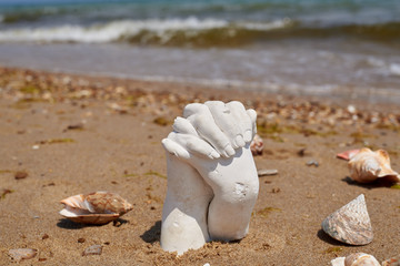 plaster cast of two hands on the seashore