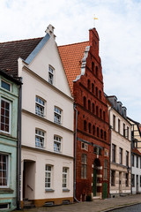 Fototapeta na wymiar Street view of old gable houses in the old city centre of Wismar. Germany