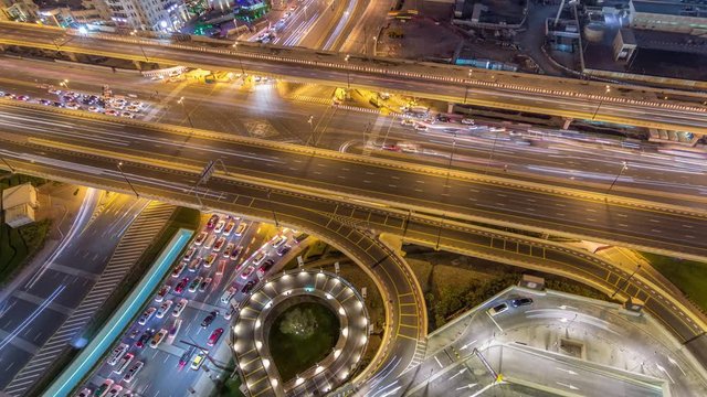 Aerial view of highway interchange in Dubai downtown night timelapse. Al Saada street and Financial center road. Cityscapes traffic bridge, logistics. Roads and lanes Crossroads, Dubai, United Arab