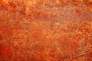 Closeup of a bright fiery red orange sheet of an old abandoned rusty metal.  Corrosion swelling, pores, leaks and other damage to the iron. Abstract, modern, trendy, texture background with copy space