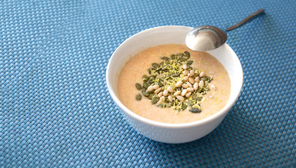 Pumpkin smoothie with pine nuts, pumpkin seed and lemon zest. Healthy diet.