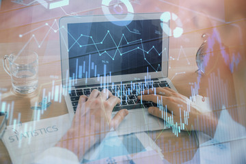 Multi exposure of market chart with man working on computer on background. Concept of financial analysis.