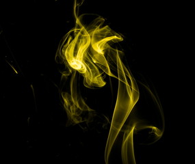 Obraz premium Yellow smoke on black background