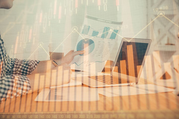 Double exposure of financial graph with man works in office on background. Concept of analysis.