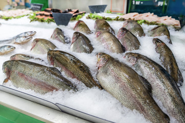 Fresh fish on ice decorated for sale at market, pink salmon