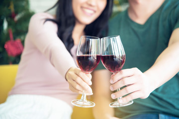 Asian couples are drinking wine happily in a warm family and celebrating near Christmas during the long holiday of the New Year.