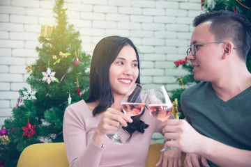 Asian couples are drinking wine happily in a warm family and celebrating near Christmas during the long holiday of the New Year.