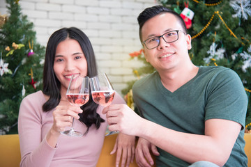 Asian couples are drinking wine happily in a warm family and celebrating near Christmas during the long holiday of the New Year.