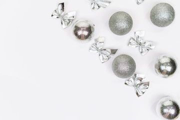 Silvar Christmas balls nd bow on white background. White copy space for your text and logo.