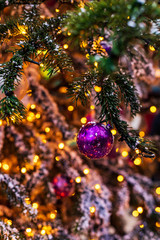 Outdoor vintage decorated Christmas tree with light garland, selective focus