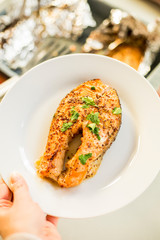 cook salmon in white plate with honey and mustard