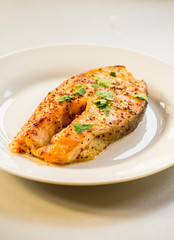 cook salmon in white plate with honey and mustard