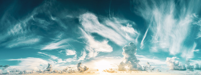 panorama of blue cloudy sky and rising sun