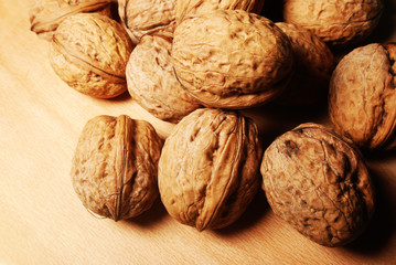 Walnuts are scattered on the table, background