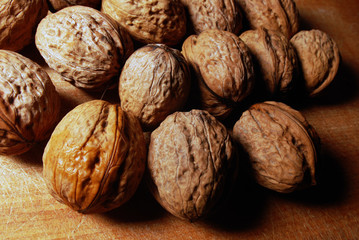 Walnuts are scattered on the table, background
