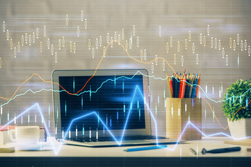 Financial graph colorful drawing and table with computer on background. Double exposure. Concept of international markets.