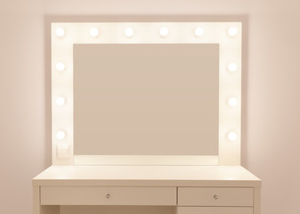 Makeup mirror with gold lights. Photo of the mirror in the make-up room. Backstage dressing room