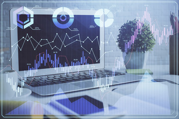 Financial chart drawing and table with computer on background. Double exposure. Concept of international markets.