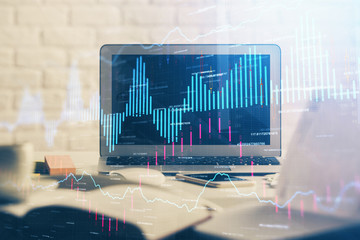 Forex market graph hologram and personal computer on background. Multi exposure. Concept of investment.