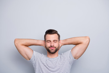 Obraz premium Close-up portrait of his he nice attractive muscular sportive dreamy cheery bearded guy in striped t-shirt resting closed eyes isolated over light grey pastel color background