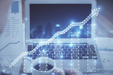 Forex market chart hologram and personal computer background. Multi exposure. Concept of investment.