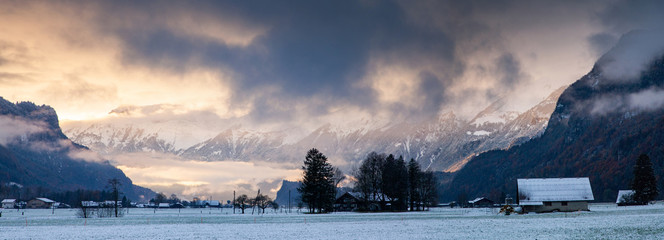 panorama of sunset and snow covered peaks in the background  Switzerland