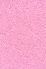 background from texture closeup of decorative plaster on a pink wall surface