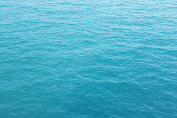 Blue Sea surface aerial view with waves from a drone, empty blank to background. soft focus.