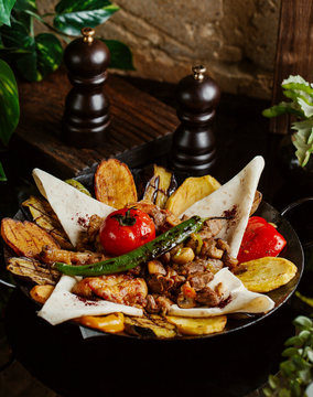 lamb saj with potato, aubergine, tomato, flatbread and pepper