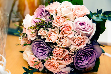  Bouquet for the bride of colorful roses lies on the table