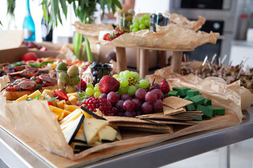 Berries and fruits on the table. Grapes, strawberries, oranges, cheese. Catering, party food