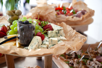 Catering, party food. Blue cheese, olives, grapes, festive table decoration