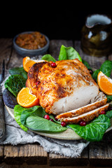 Delicious sliced turkey breast for Thanksgiving Day table on wooden board