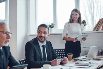Professional business expert conducting meeting while working together with colleagues in the...