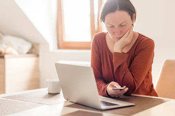 Woman telecommuting in home office interior