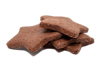 A pile of delicious homemade chocolate and sugar cookies in the shape of stars isolated on a white background. Holiday baking for the whole family