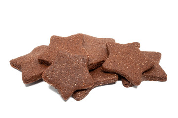 A pile of delicious homemade chocolate and sugar cookies in the shape of stars isolated on a white background. Holiday baking for the whole family