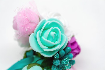 Closeup view of a beautiful multi-colored bouquet of artificial tender rose flowers in delicate pastel colors. Selective focus