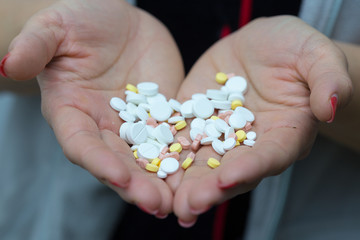 girl wants to drink a lot of pills on a white background