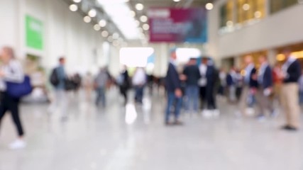 Blurred crowd of people walking around at a trade fair