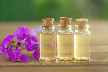 Essence of flowers on table in beautiful glass jar