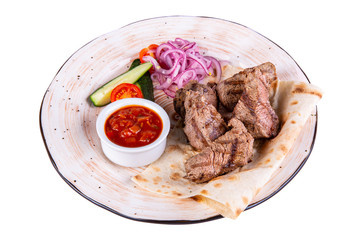 Beef fried on coal with ketchup and vegetables