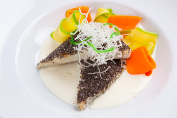fish in white sauce with vegetables