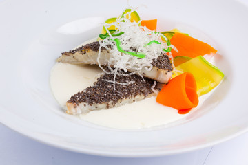 fish in white sauce with vegetables