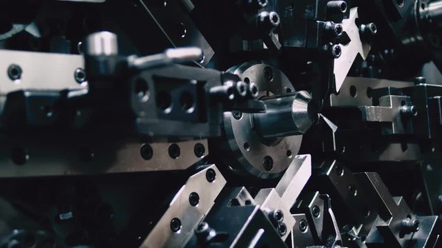 Automated equipment for producing steel springs. Engineering and industry concept.