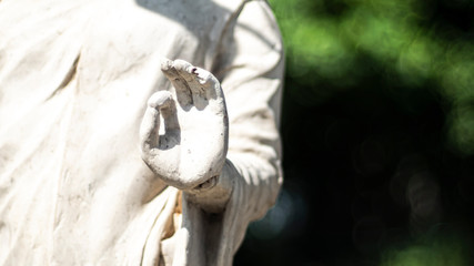 Statue of Buddha standing in meditation.Close up hand of statue Buddha.buddhism concept .peacefulness idea .lifestyle practise mind in clamness