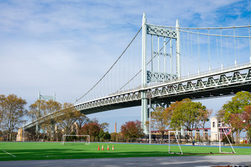 Fototapeta na wymiar Astoria Park with a Soccer Field looking towards the Triborough Bridge in Astoria Queens New York