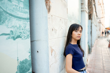 Confident woman Leaning on the wall