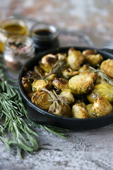 Baked Brussels sprouts with rosemary and spices. Frying pan with baked brussels sprouts.